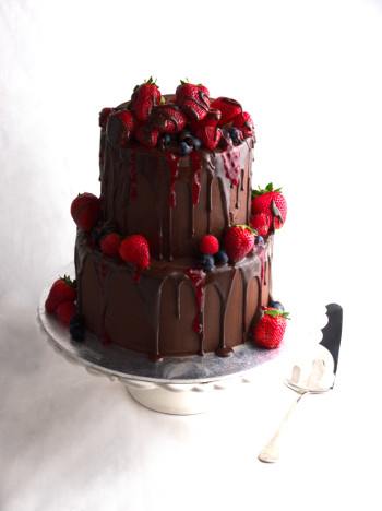 chocolate cake, berries strawberries and dripping berry glaze
